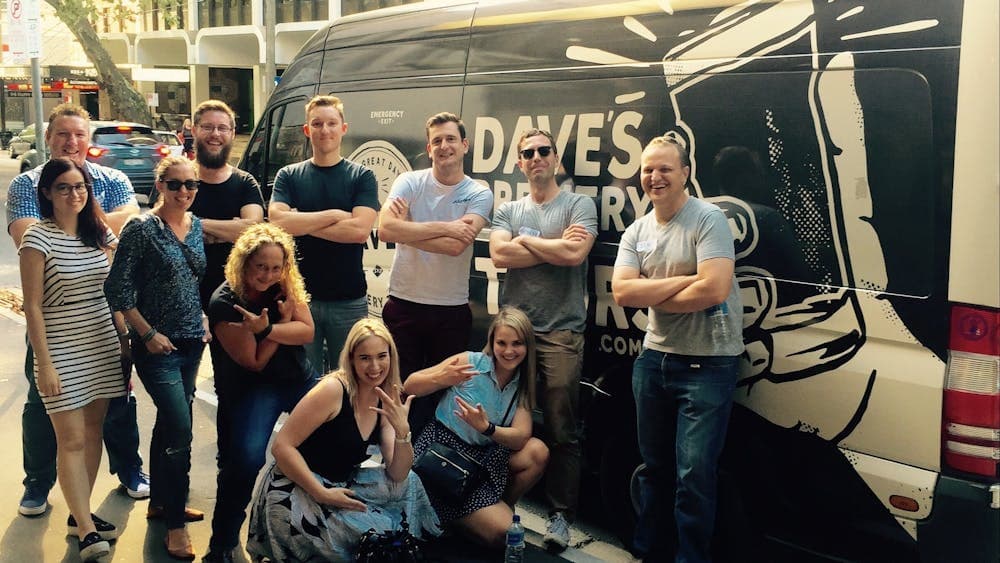 Beer tour participants in front of the Dave's Brewery Tour bus