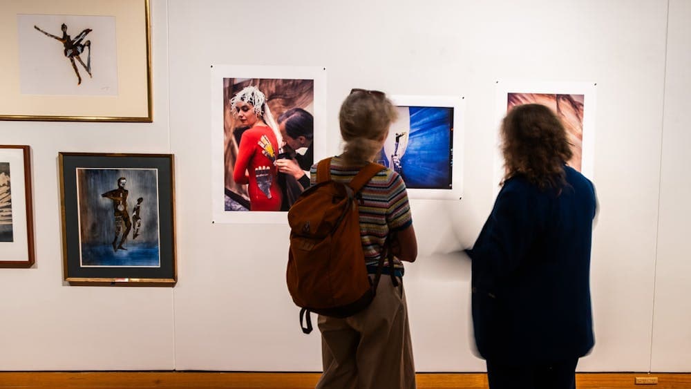 Two people exploring the exhibition A Total Work of Art: Sidney Nolan and the Stage