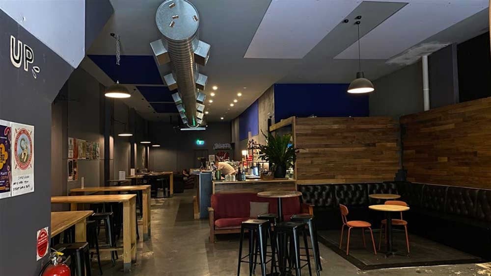 Image of Dissent Cafe & Bar's cozy and industrial style interior.