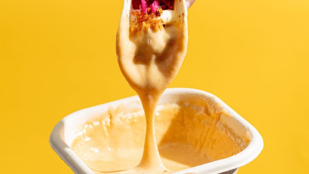 Tacos dipped in our house nachos cheese sauce