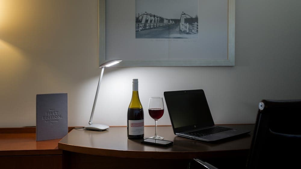 Large working style desk with a bottle of local wine from Lerida estate