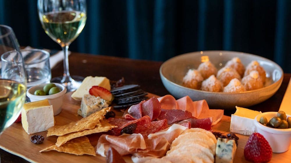 Selection of Tilba cheeses with membrillo, cornichons,  muscatels and Fedra olives