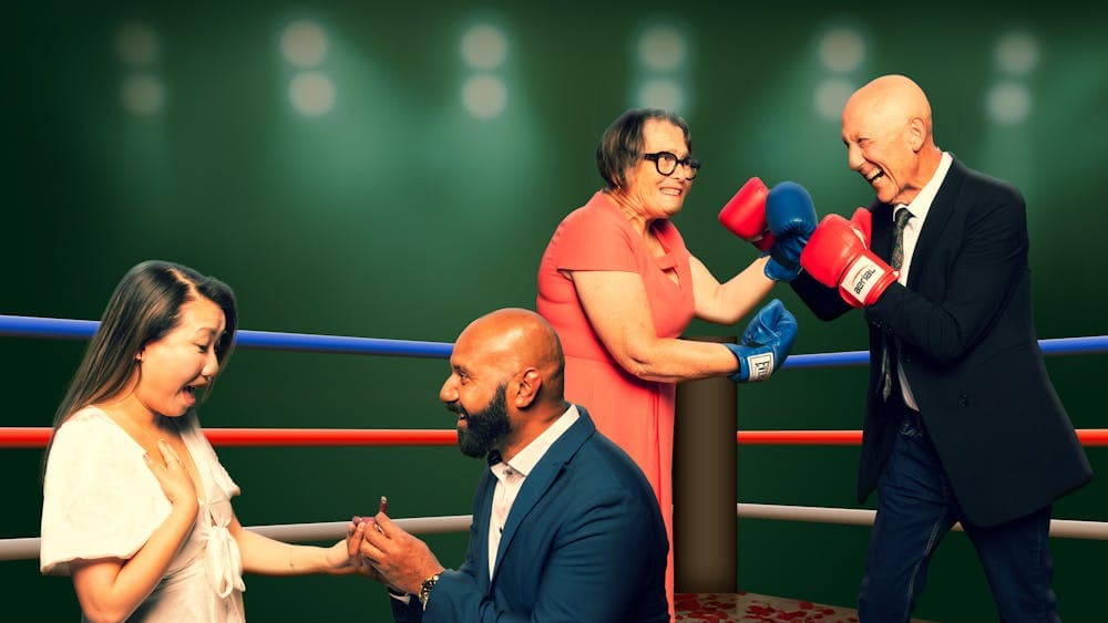 Two male and female couples . 1 man proposing to a woman. the other couple wearing boxing gloves