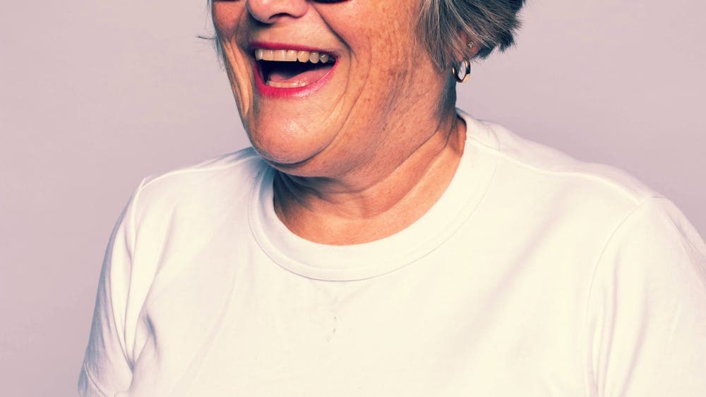 Woman wearing white top smiling