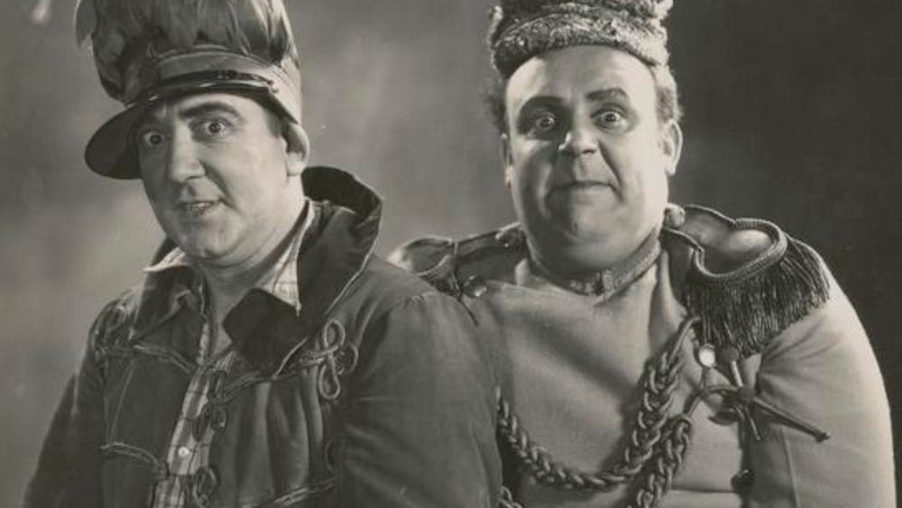 Black and white photo of two men dressed as kings