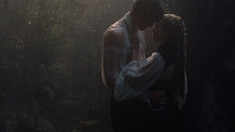 A woman and man embrace in the rain