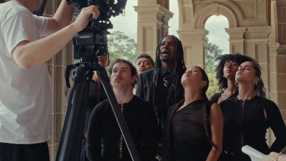 Camera shooting group of people singing towards it