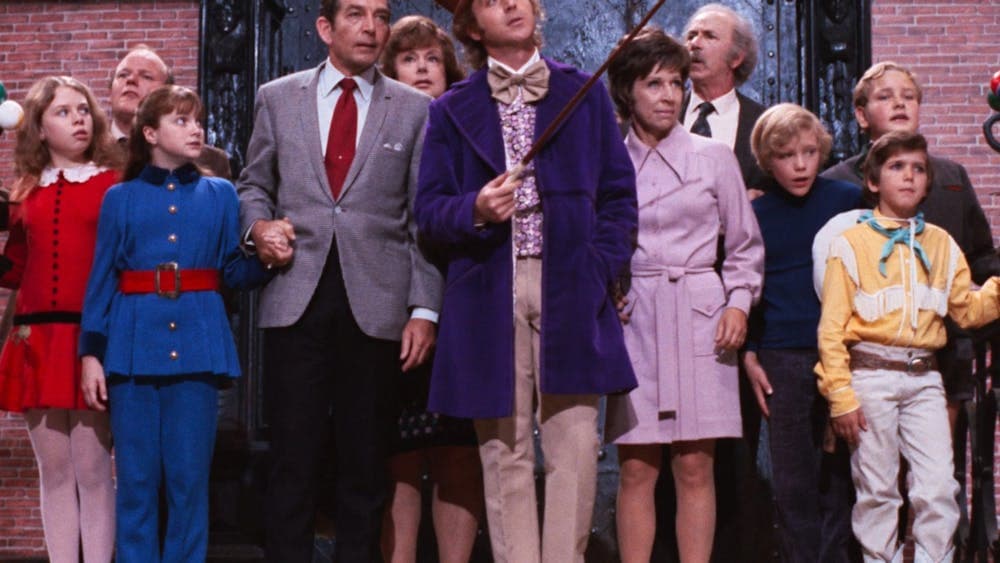 Group of adults and children all looking curious towards the side