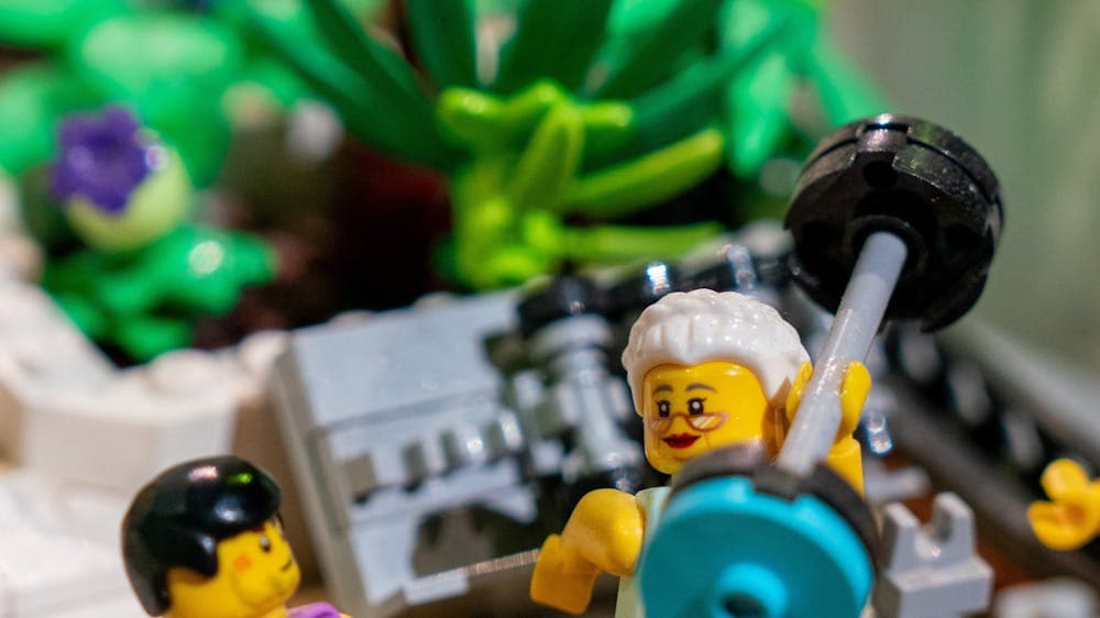 LEGO® minifigure in gym lifting weight in RELICS exhibit