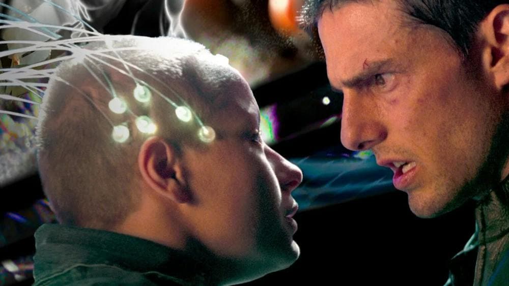 Man looks sternly at young child with nodes attached to the head