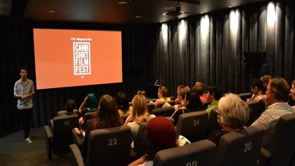 Movie Screen showing CSFF logo with audience watching